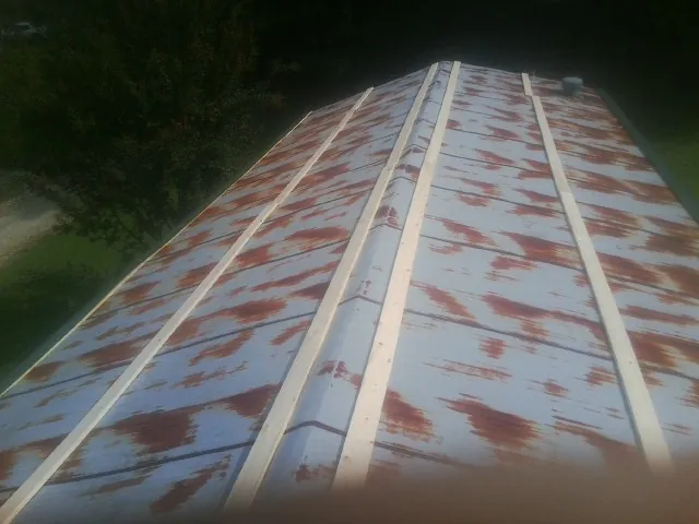 Rusted metal roof panels with new wood purlins before replacement — Storm Damage Roof Repair in Waretown by Roofing Brothers