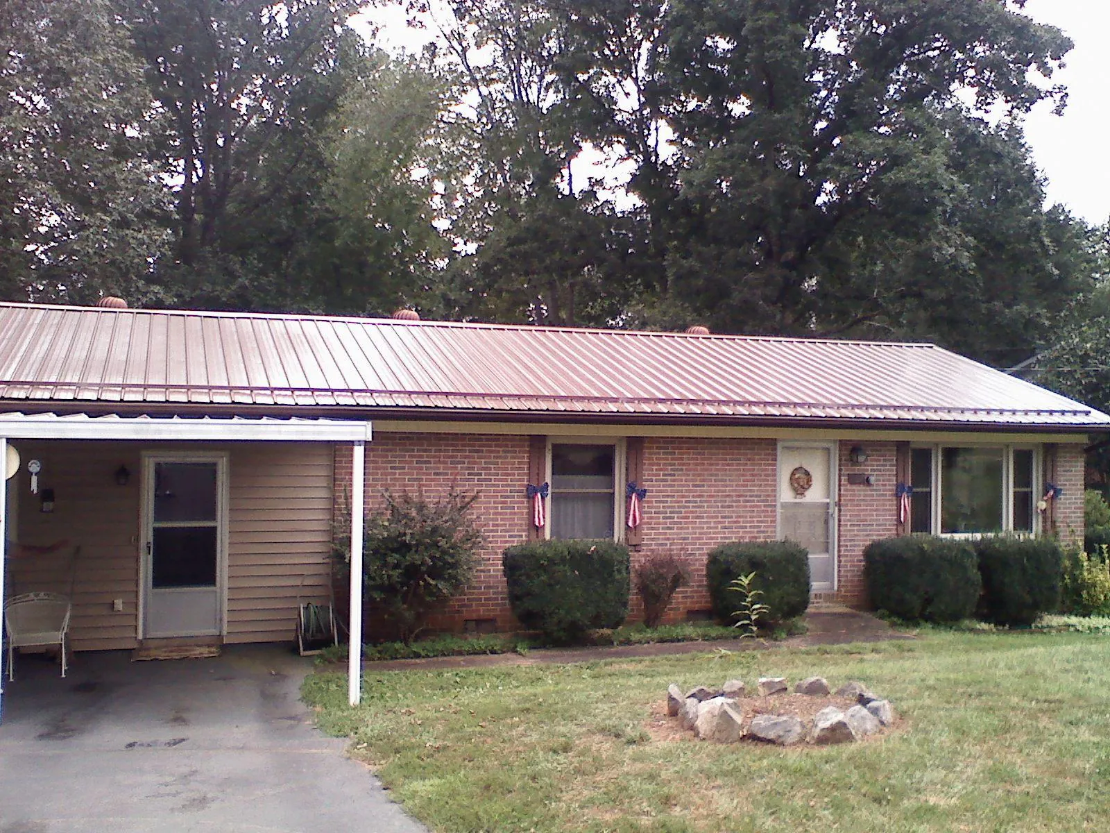 Bronze metal roof and carport on a brick ranch home — Roof Repair work by our crew in Waretown